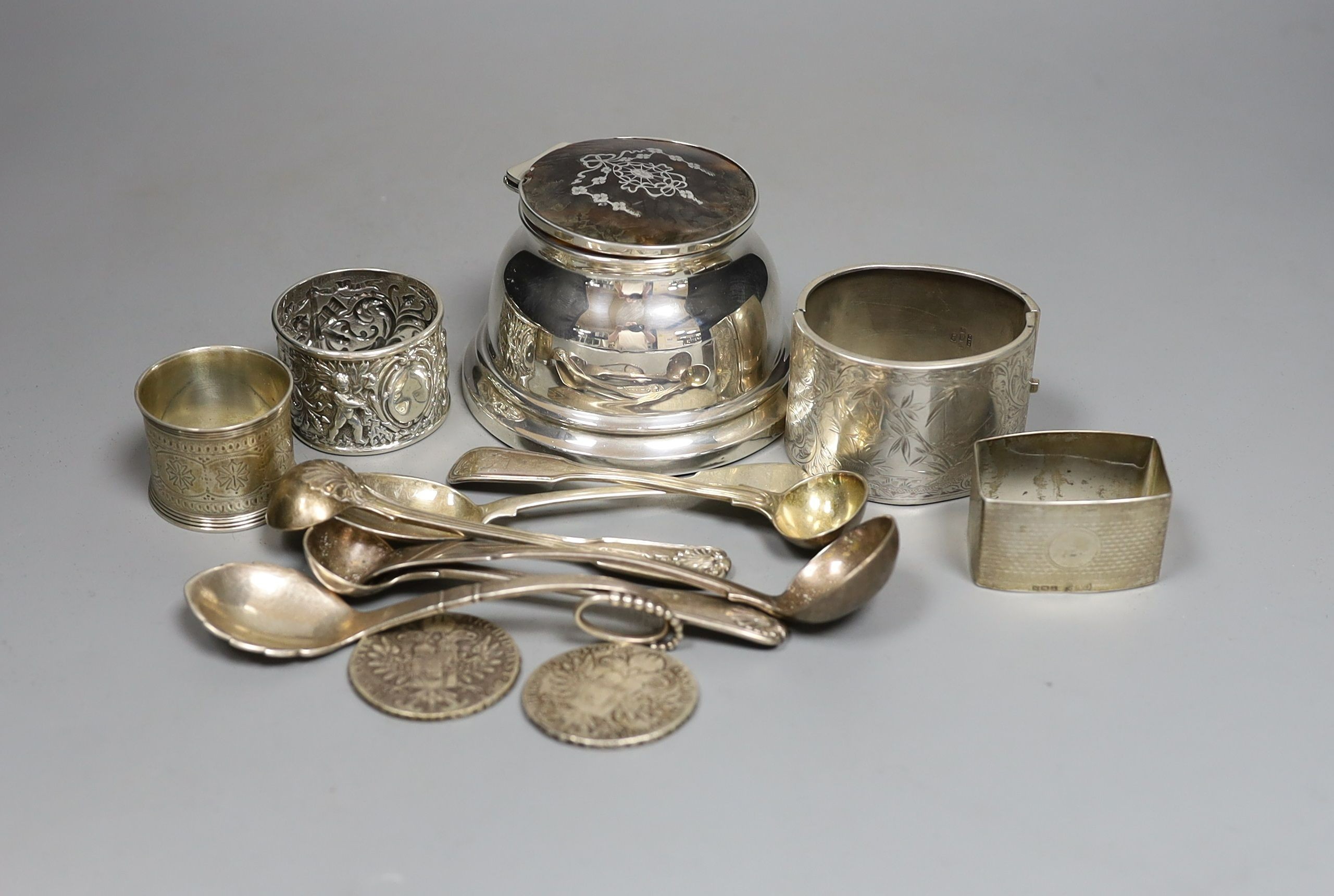 Assorted small silver including flatware, napkin rings, tortoiseshell mounted inkwell, two coins and a Georg Jensen sterling preserve spoon, no. 41.